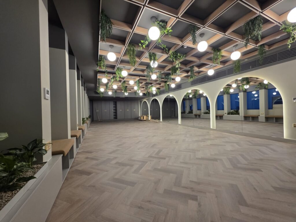 Open-plan commercial office after painting and decorating, with arched alcoves and wood flooring